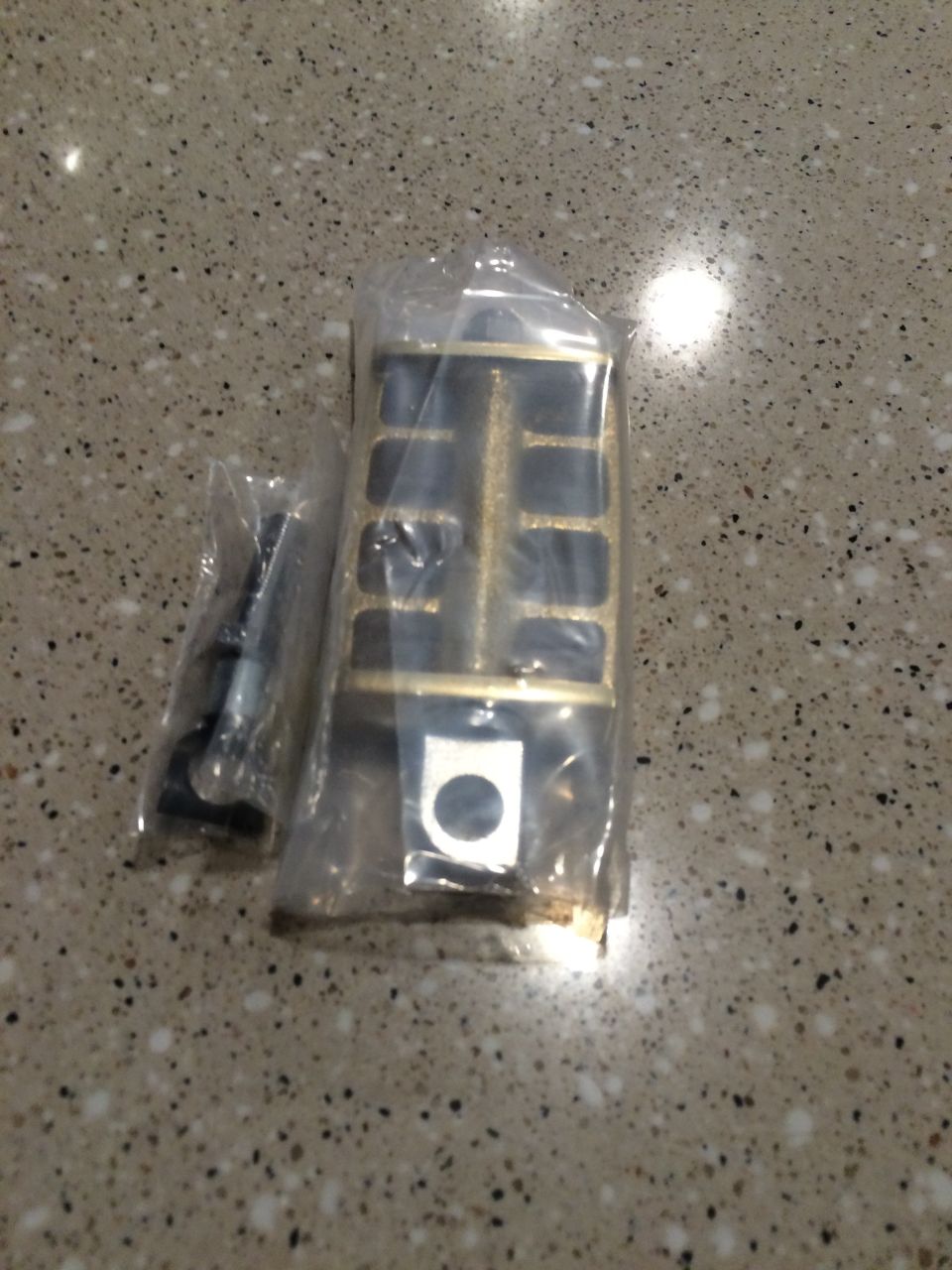 Motorcycle foot peg in plastic packaging with hardware