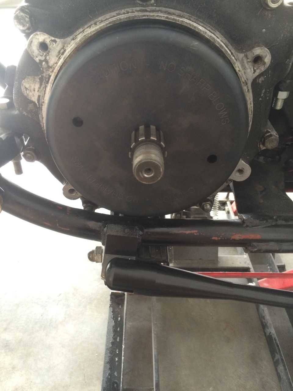 Motorcycle transmission cover with caution text and splined shaft