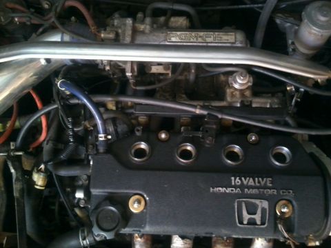 1991 Honda CRX - Close-up of a Honda engine, showing the 16-valve engine cover and PGM-FI fuel injection system.