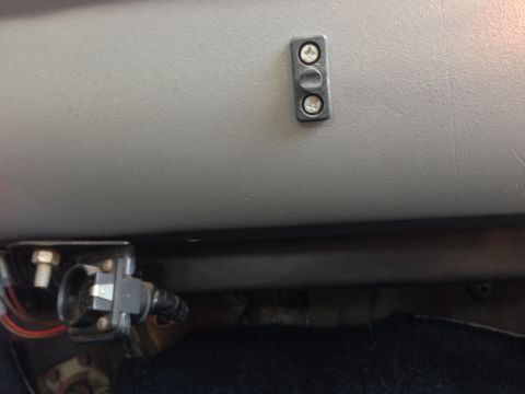 1979 Ford Bronco - Close-up view of a dashboard switch and electrical connector inside a vehicle.