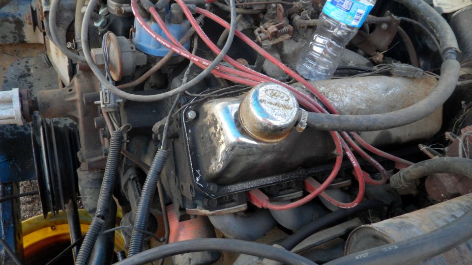 Ford V8 engine with chrome valve cover and red spark plug wires