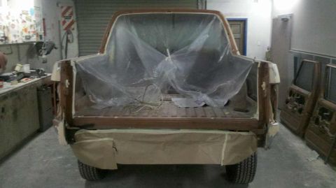 1982 Ford Bronco - This 1980s Ford Bronco is in a workshop, partially covered in plastic for panel work.