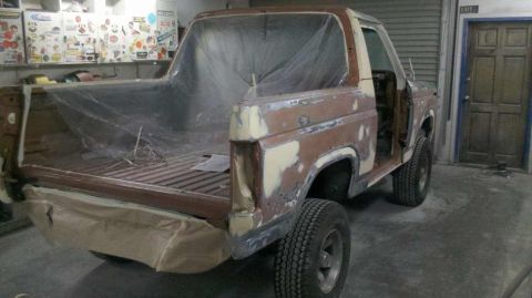 1982 Ford Bronco - This 1982 Ford Bronco is undergoing bodywork and is covered in primer and protective plastic sheeting.
