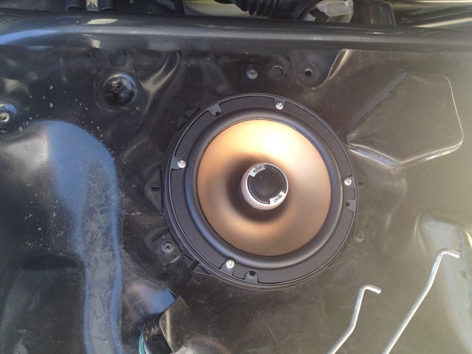 Car door panel with a Polk audio speaker installed