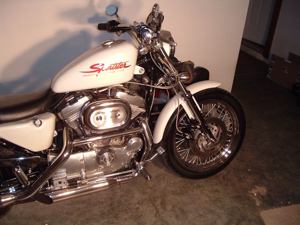 White Harley-Davidson Sportster motorcycle, front wheel and engine visible