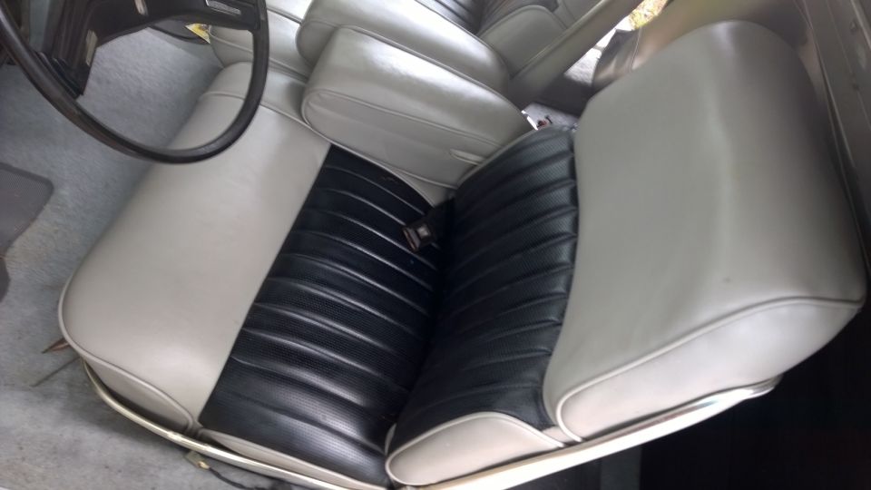 Car interior with two-tone seats, black and beige, and a steering wheel