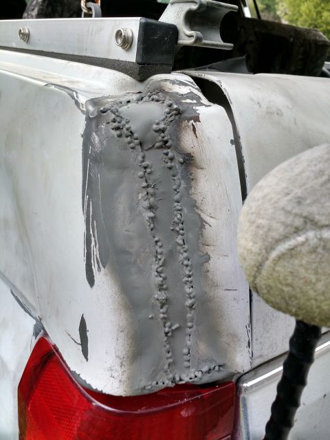 1992 Ford Bronco - This 1992 Ford Bronco shows significant body damage and crude welding repairs on its rear corner.