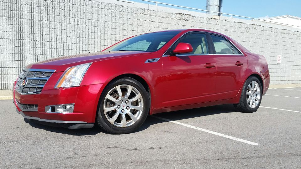 Red 2008 Cadillac CTS sedan parked in a lot, front 3/4 view