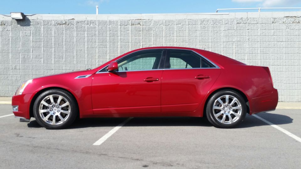 Side view of a red 2008 Cadillac CTS parked in a lot