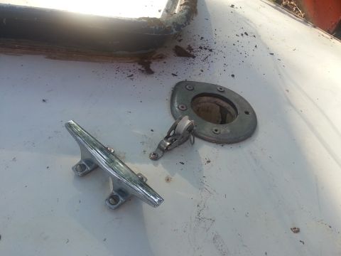 1973 Ford F-100 - Close-up view of a boat's deck hardware, including a cleat and a pulley system.