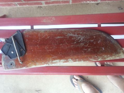 1973 Ford F-100 - A weathered wooden section, possibly from a boat hull, is shown with a metal bracket.