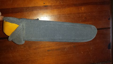 1995 Ford Bronco - A gray and yellow car part is shown resting on a wooden surface.