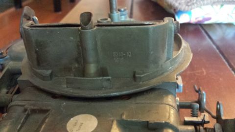 1995 Ford Bronco - A carburetor part with visible markings is shown in detail.