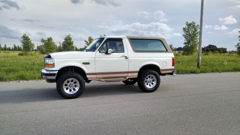 1994 Ford Bronco - This 1992 Ford Bronco is shown from the side, a lifted suspension and aftermarket wheels.