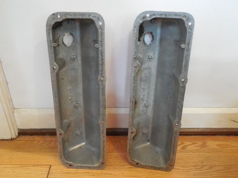1973 Ford Mustang - Pair of engine valve covers, possibly for a classic car, displayed on a wooden floor.