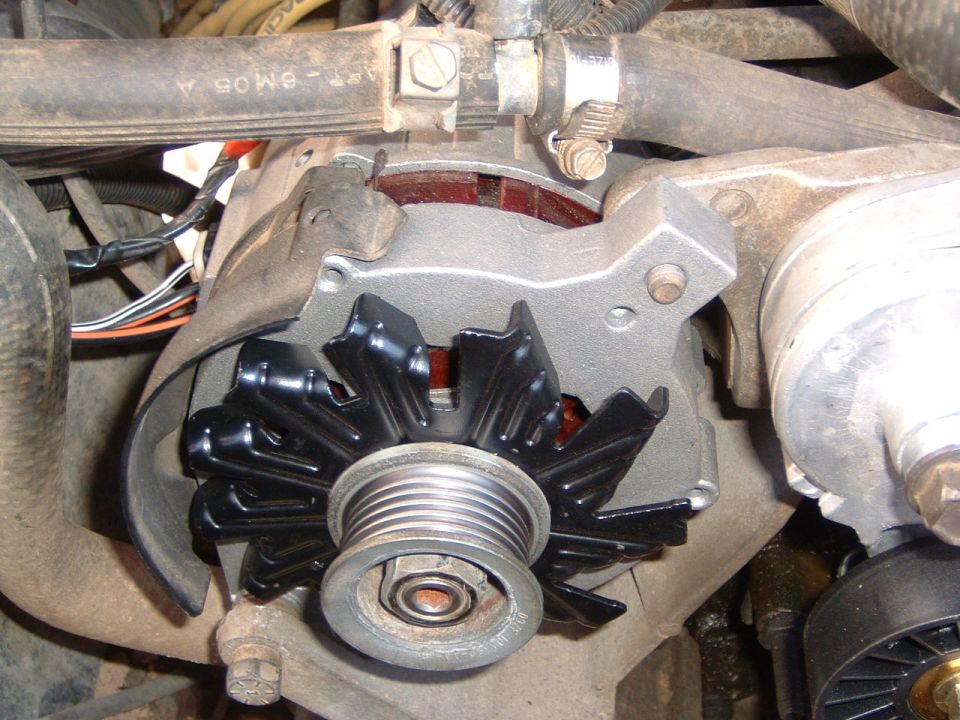 Alternator with black fan and pulley, close-up view