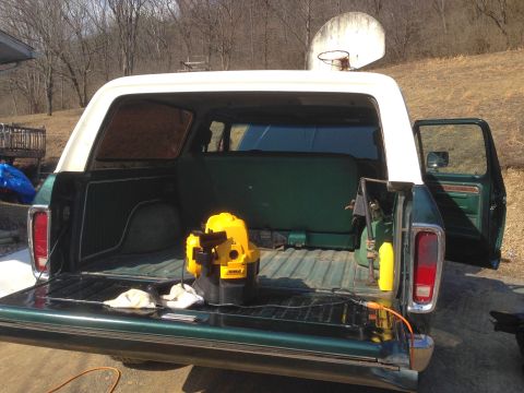 1979 Ford Bronco - Cleaning out the cargo area of a 1978 Ford Bronco, showing the rear bench seat and equipment.