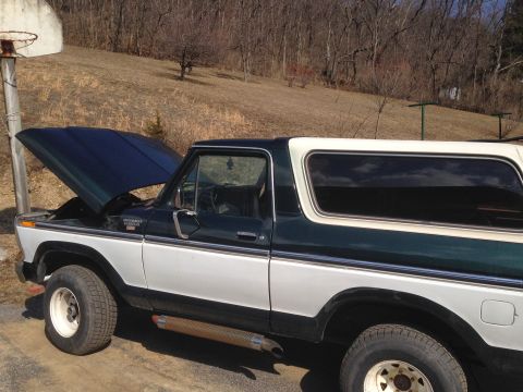 1979 Ford Bronco - This two-tone green and white Ford Bronco has its hood up, revealing the engine bay.