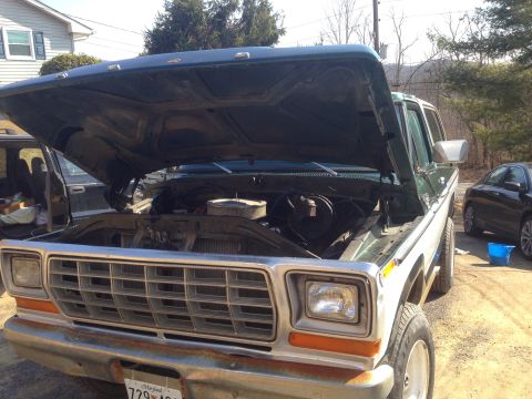 1979 Ford Bronco - The front of a 1978 Ford Bronco is shown with its hood open, revealing the engine compartment.