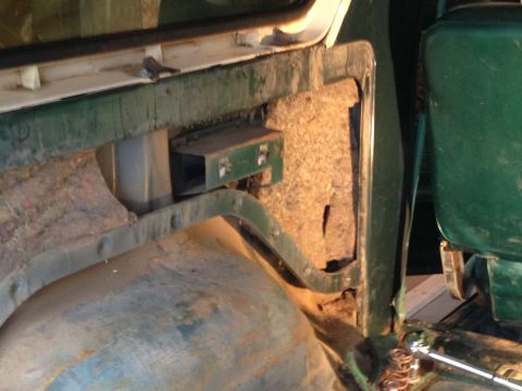 1979 Ford Bronco - The interior of a 1979 Ford Bronco shows the door panel and a green seat, suggesting a clean-up project.