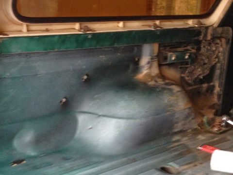 1979 Ford Bronco - The rear cargo area of the vehicle shows signs of wear and tear, with rust and debris present.