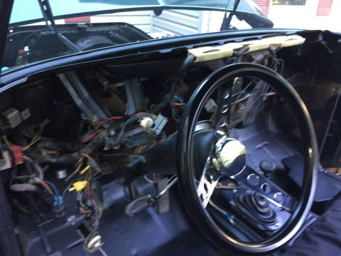 1979 Ford Bronco - Dashboard wiring is exposed for repair or modification in this vehicle interior.