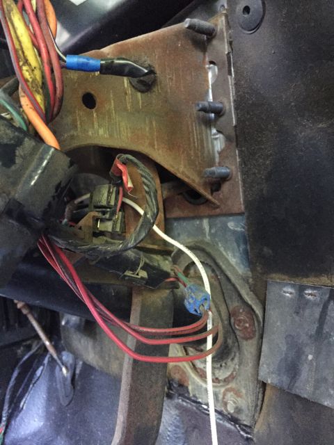 1979 Ford Bronco - Close-up view of a vehicle's wiring harness and mounting bracket, likely from the dashboard area.