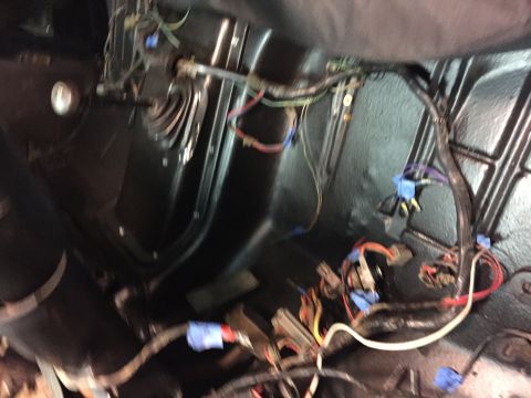 1979 Ford Bronco - This is a close-up, blurry shot of a vehicle's interior wiring harness, likely in the footwell area, with various wires, connectors, and bl…