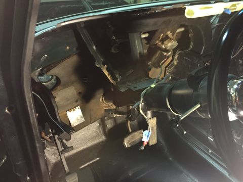 1979 Ford Bronco - Interior view of a classic vehicle's dashboard and steering column area, showing exposed wiring, pedals, and parts of the steering wheel. T…