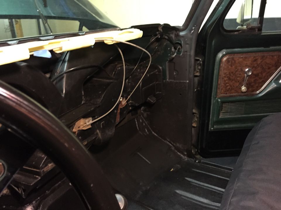 Interior of a 1979 Ford Bronco showing dashboard, steering wheel, and door panel.