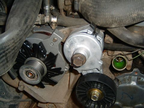 1987 Ford Bronco - Close-up view of engine components including an alternator and pulleys.