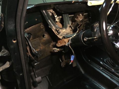 1979 Ford Bronco - This is an interior view of a vehicle's dashboard and steering column area, showing exposed wiring and mechanical components. The image foc…