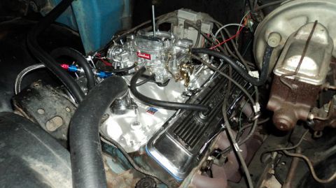 1979 Ford Bronco - A close-up view of a V8 engine with a chrome Edelbrock carburetor and chrome valve covers. Various hoses and wiring are visible, along with…