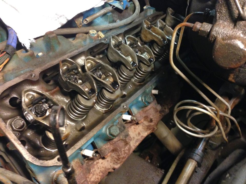Close-up of a V8 engine's valve train with rocker arms and springs.
