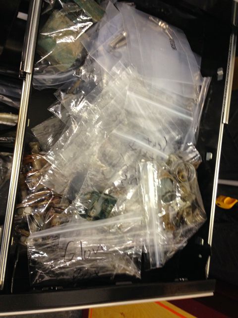 1979 Ford Bronco - Assorted small parts and bolts stored in labeled clear plastic bags inside a tool box drawer.