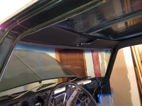 1979 Ford Bronco - Interior view of a vintage vehicle, likely a 1979 Ford Bronco, showing the windshield, dashboard, steering wheel, and headliner. The vehicl…