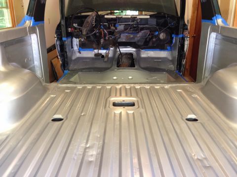 1979 Ford Bronco - The interior and bed of a classic pickup truck are shown after being painted silver. The dashboard and steering wheel are visible in the fr…