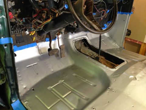 1979 Ford Bronco - The interior of a classic vehicle, likely a 1979 Ford Bronco, shows a newly installed metal floor pan and the dashboard area with exposed w…
