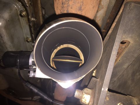 1992 Ford Bronco - A close-up view of an exhaust cut-out valve installed on the exhaust system of a vehicle. The valve is open, showing the internal butterfly…