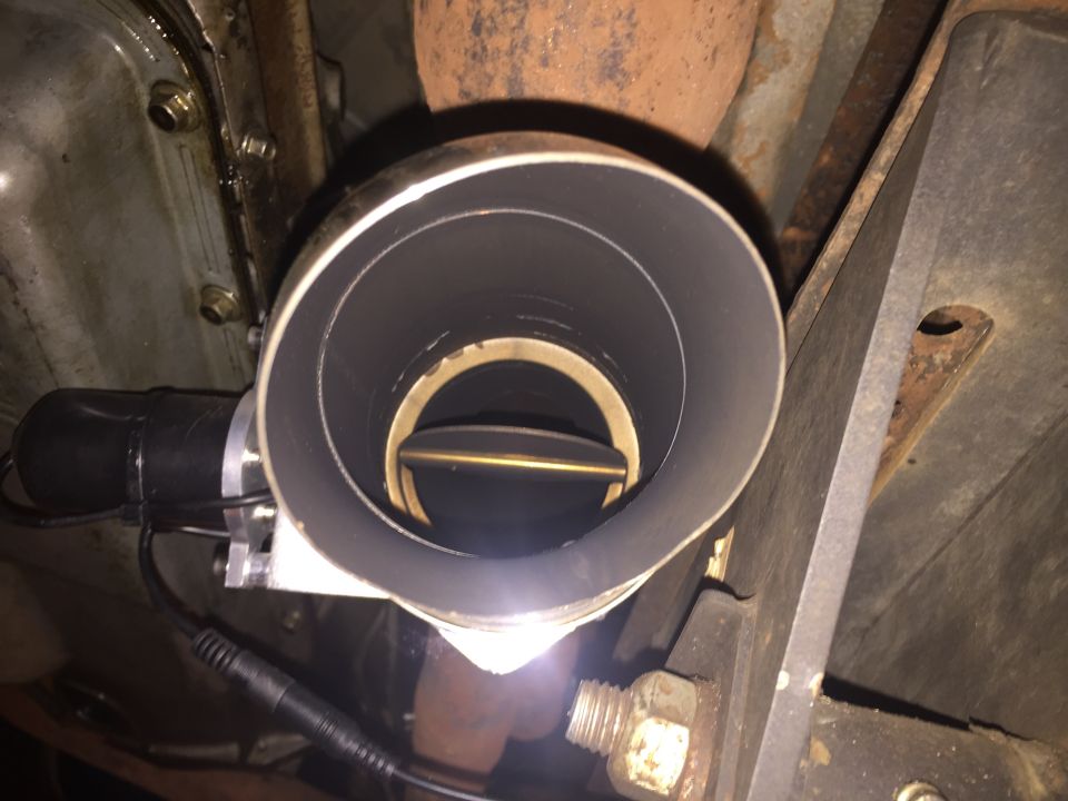 Exhaust cut-out valve installed on a vehicle's exhaust pipe, shown open.