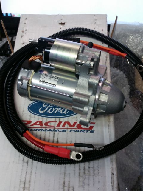 2003 Ford Crown Victoria - Photo of a new starter motor with power leads resting on a Ford Racing Performance Parts box.