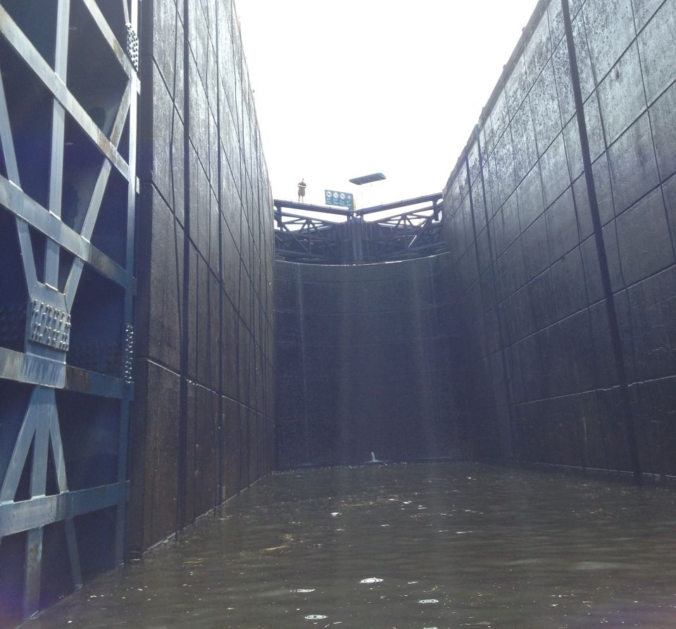 Inside a lock chamber with water and large metal gates.
