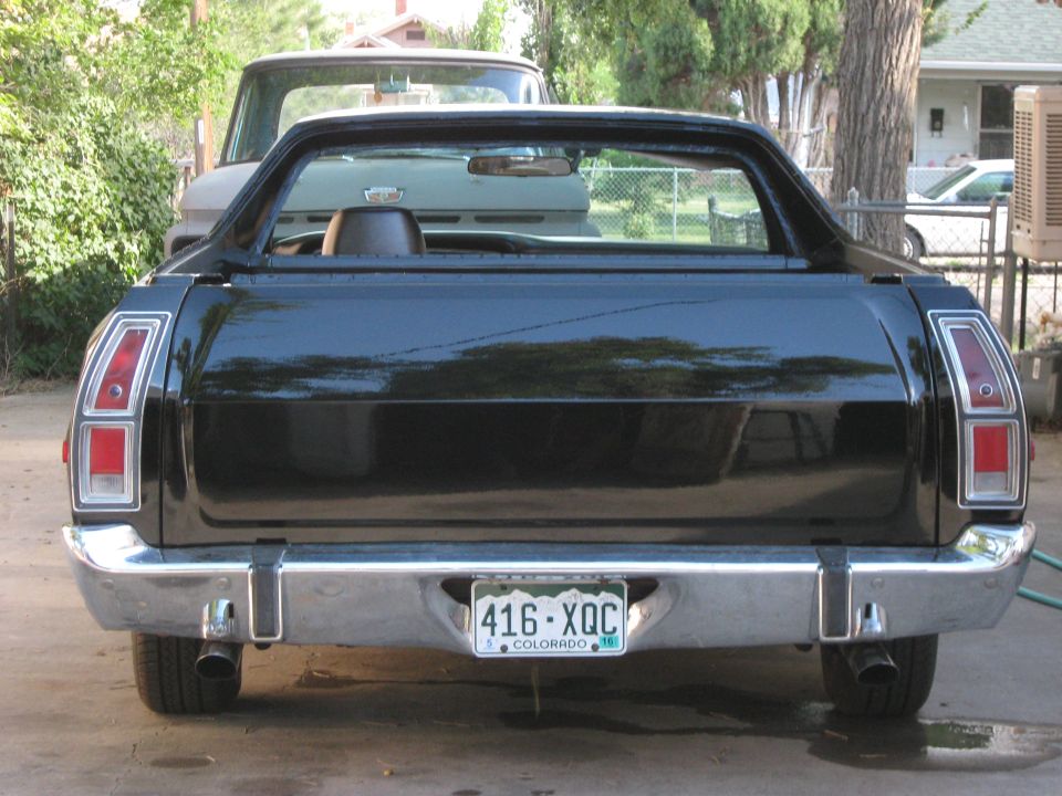 Rear view of a black 1973 Ford Ranchero with a chrome bumper and Colorado license plate.