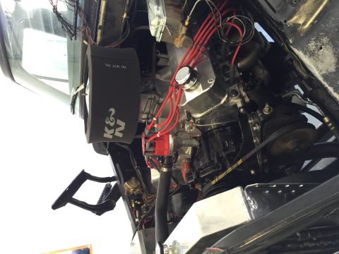 1979 Ford Bronco - Close-up view of an engine bay a K&N air filter and prominent red spark plug wires.