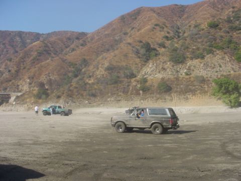 1988 Ford Bronco - Ford Bronco and pickup truck in a dry, mountainous landscape.