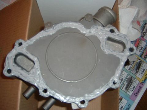1987 Ford Bronco - A water pump component, prepared with sealant for installation, is shown in a box.