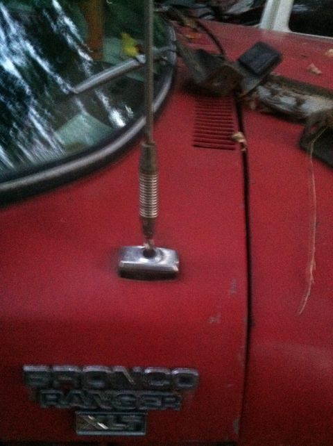 1979 Ford Bronco - The 'BRONCO RANGER XLT' badge on the hood of this red 1979 Ford Bronco confirms its identity and trim level.