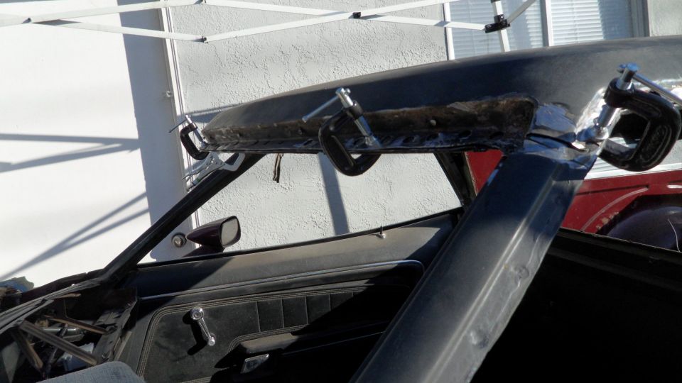 car roof being worked on with clamps