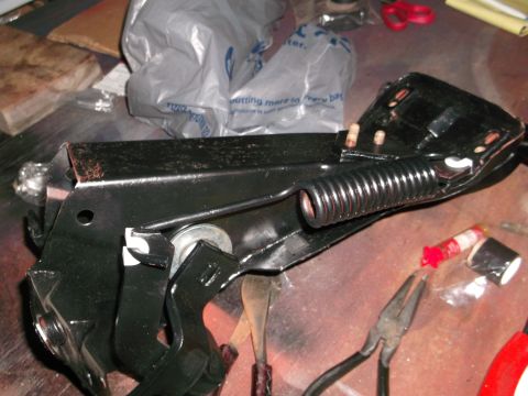 1967 Ford Mustang - A close-up view of a car part, possibly a clutch or brake pedal assembly, with tools scattered around.