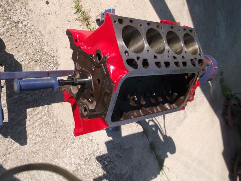 1957 Ford Custom Sedan - A red engine block is mounted on a stand, ready for assembly or inspection.